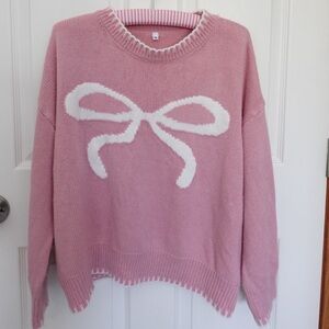 Pink Sweater with White Bow Design